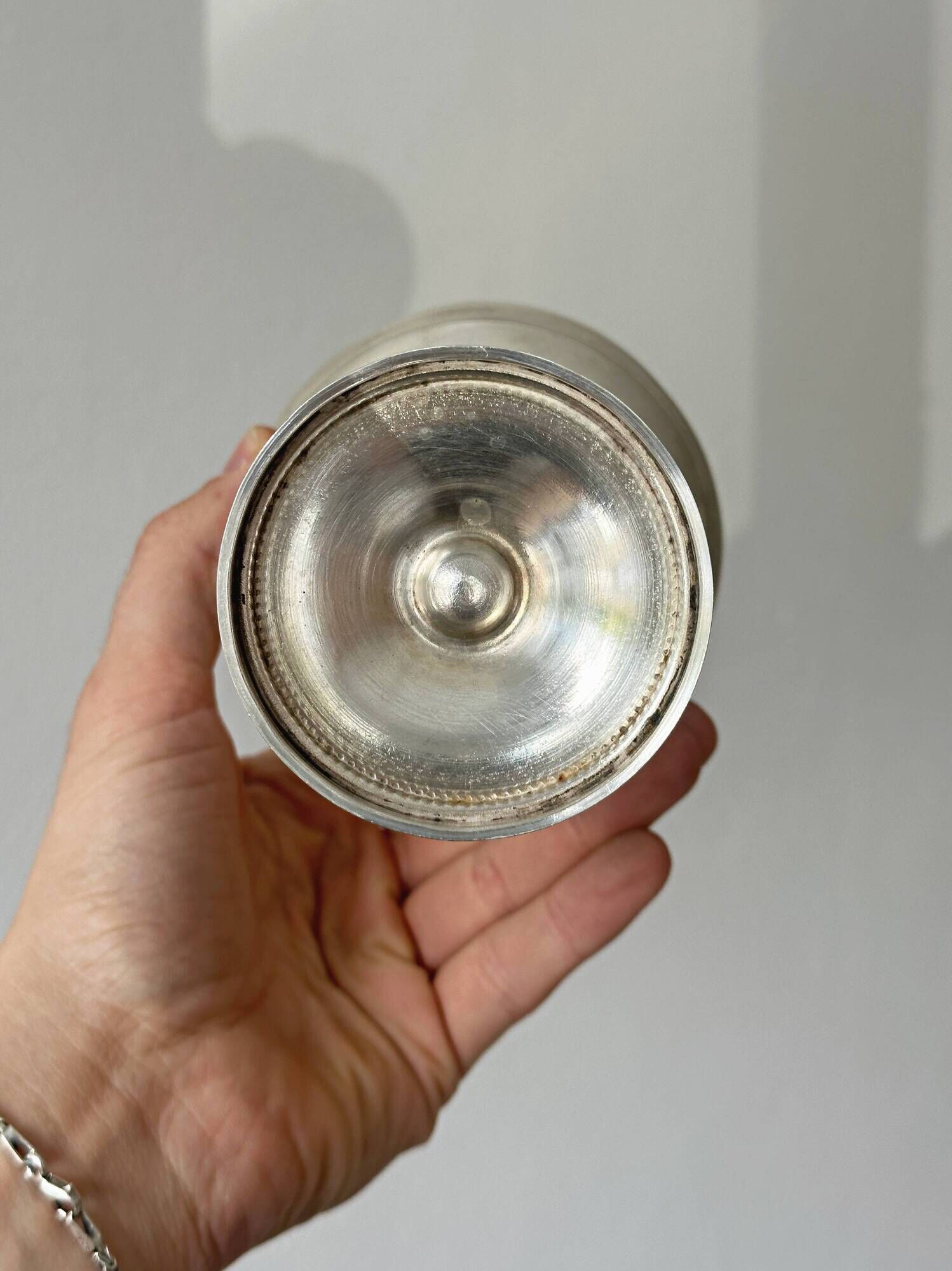Silver-plated metal stand.