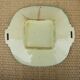 Old square plate in slipware with plant decoration.