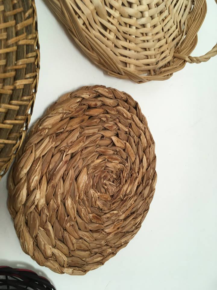 Wall composition of seven baskets and wicker trays