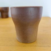 Stoneware cups – Armor stoneware set of 10 and an 11th French stoneware cup.
