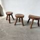 Set of three rustic solid wood tripod stools.