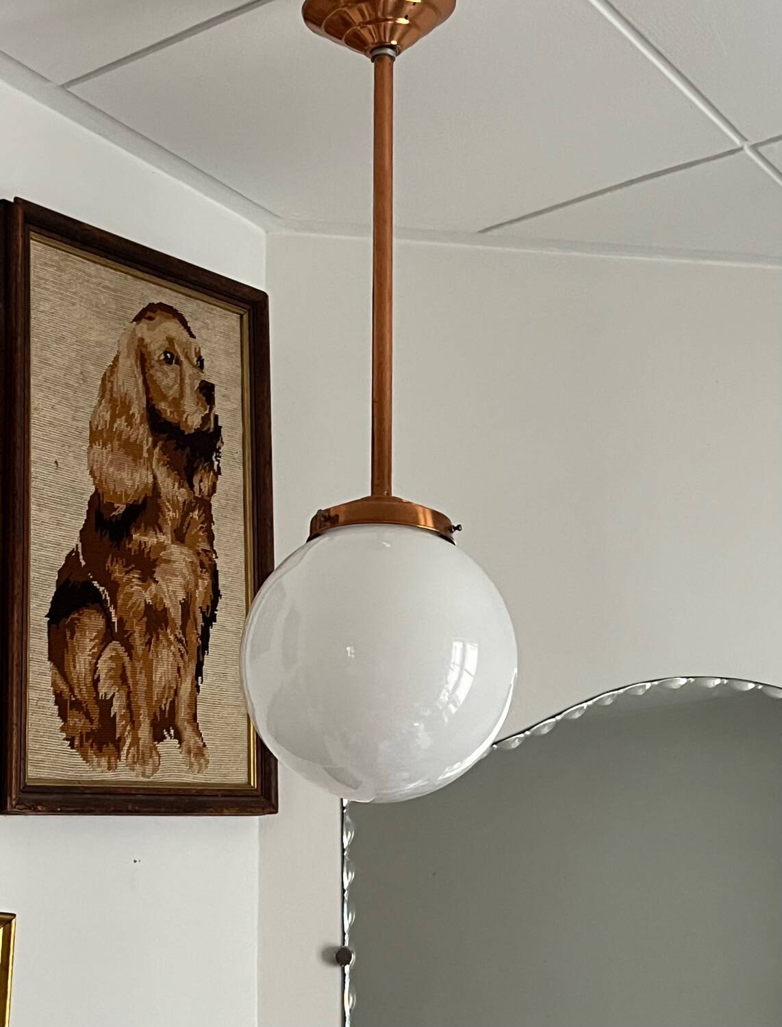 Opaline white globe pendant light with metal stem, Art Deco style.