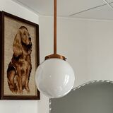 Opaline white globe pendant light with metal stem, Art Deco style.