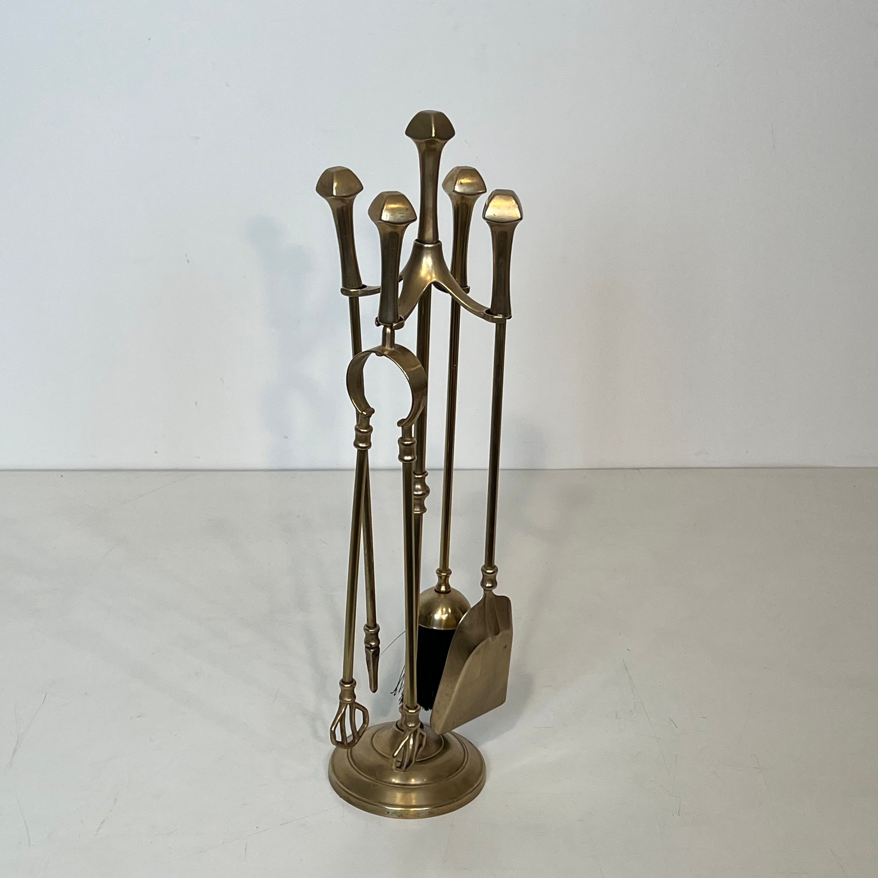 Neoclassical brass fire accessory.