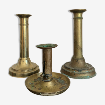 Trio of patinated vintage brass candlesticks