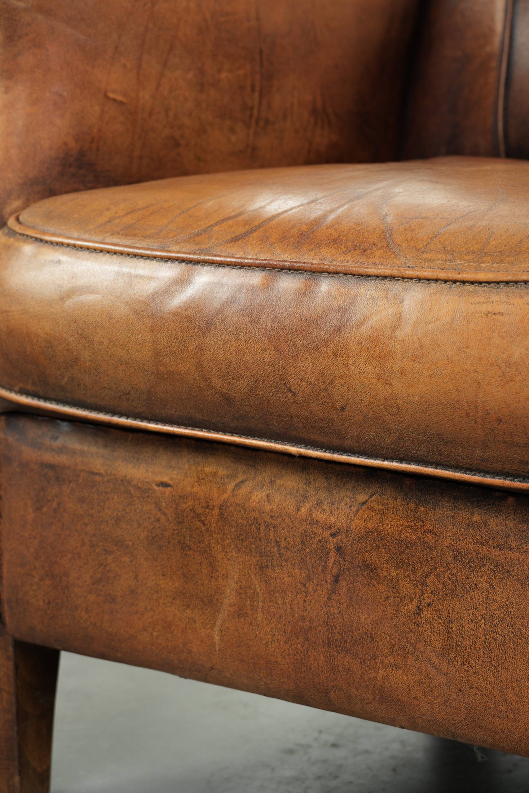 Comfortable characterful sheepskin armchair finished with decorative nails