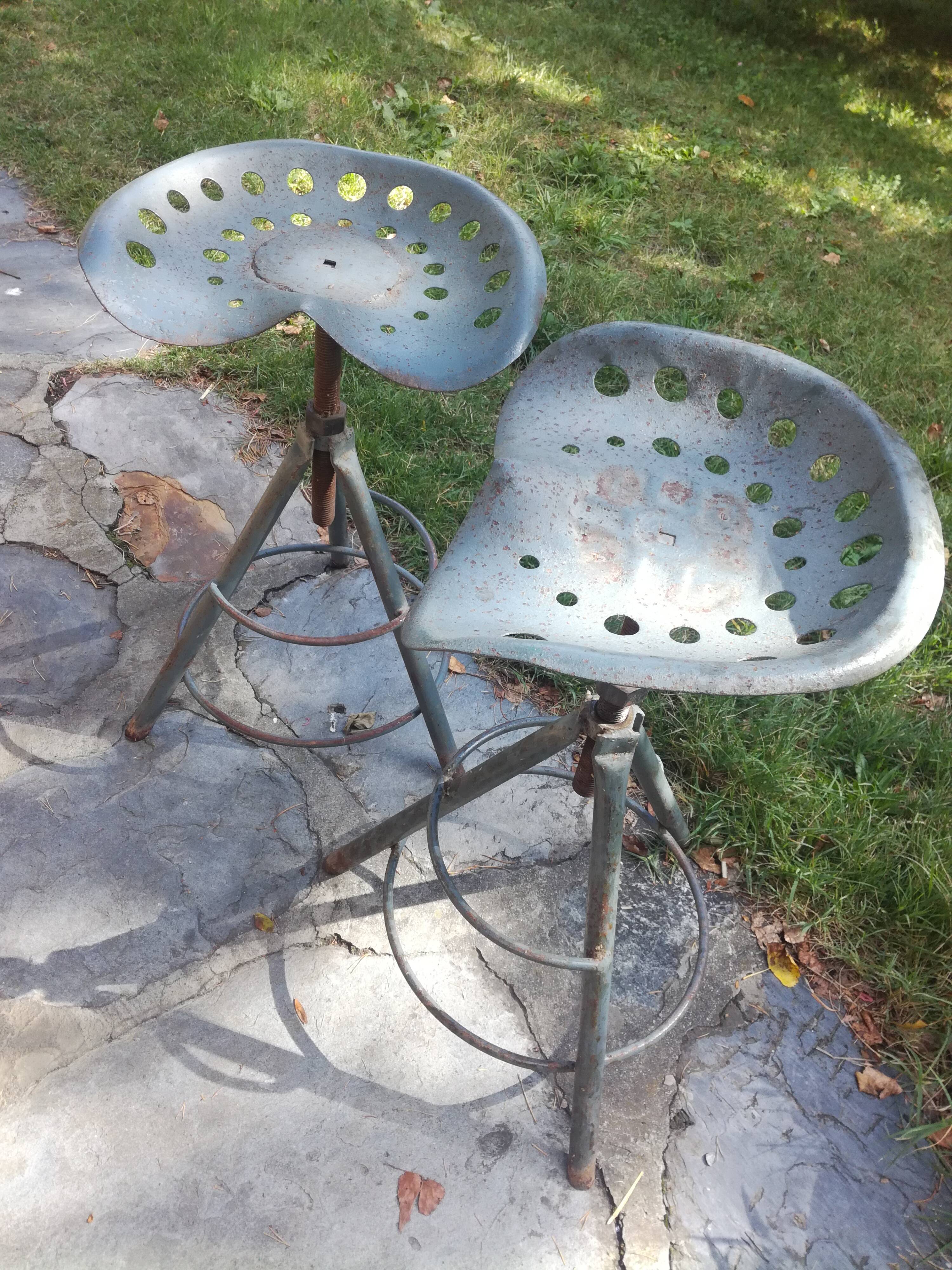 Two tractor-style industrial stools