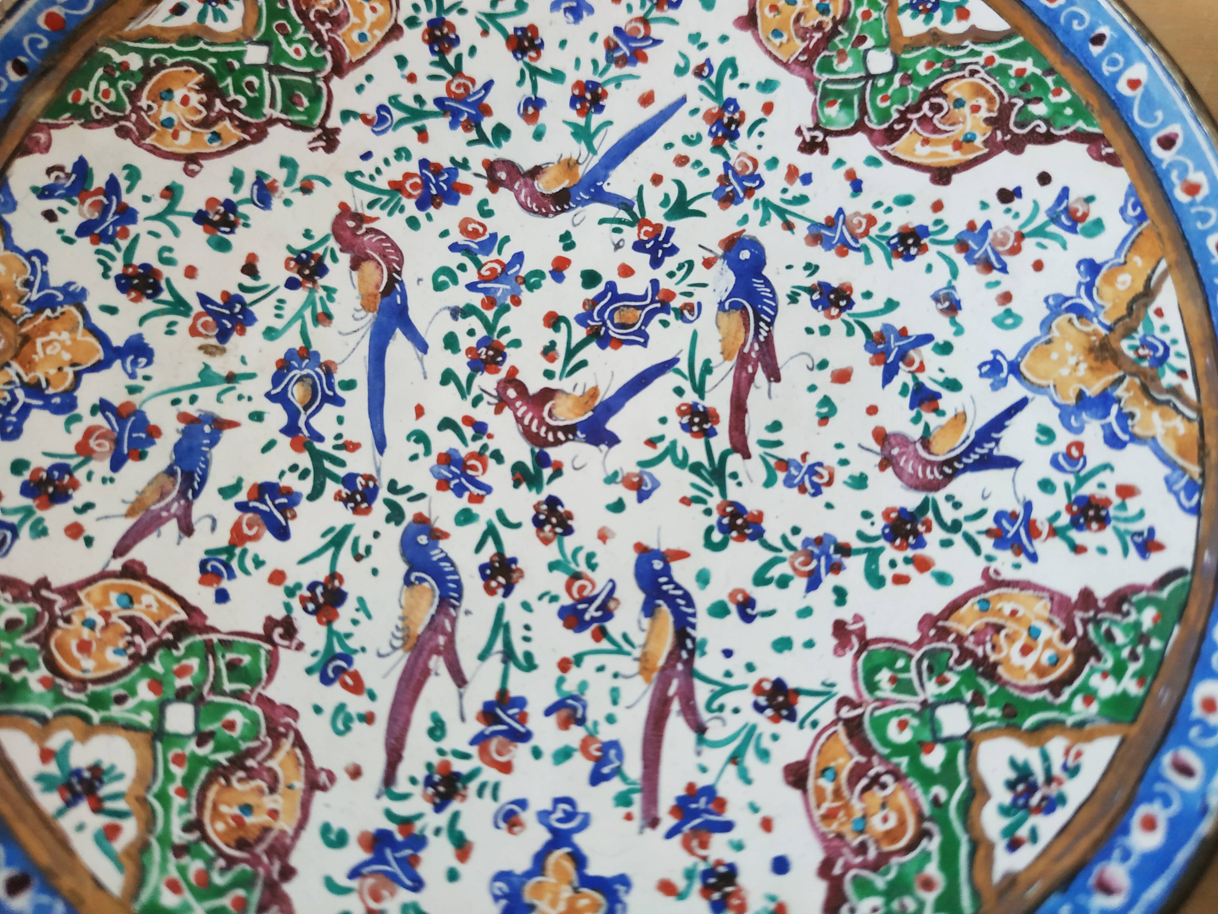 Plate and two decorative saucers enamelled with Persia decoration, circa 1940