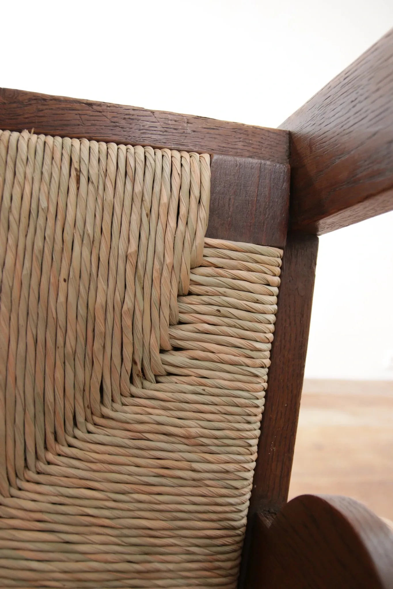 Pair of low Brutalist oak lounge chairs with new rush seats – circa 1935