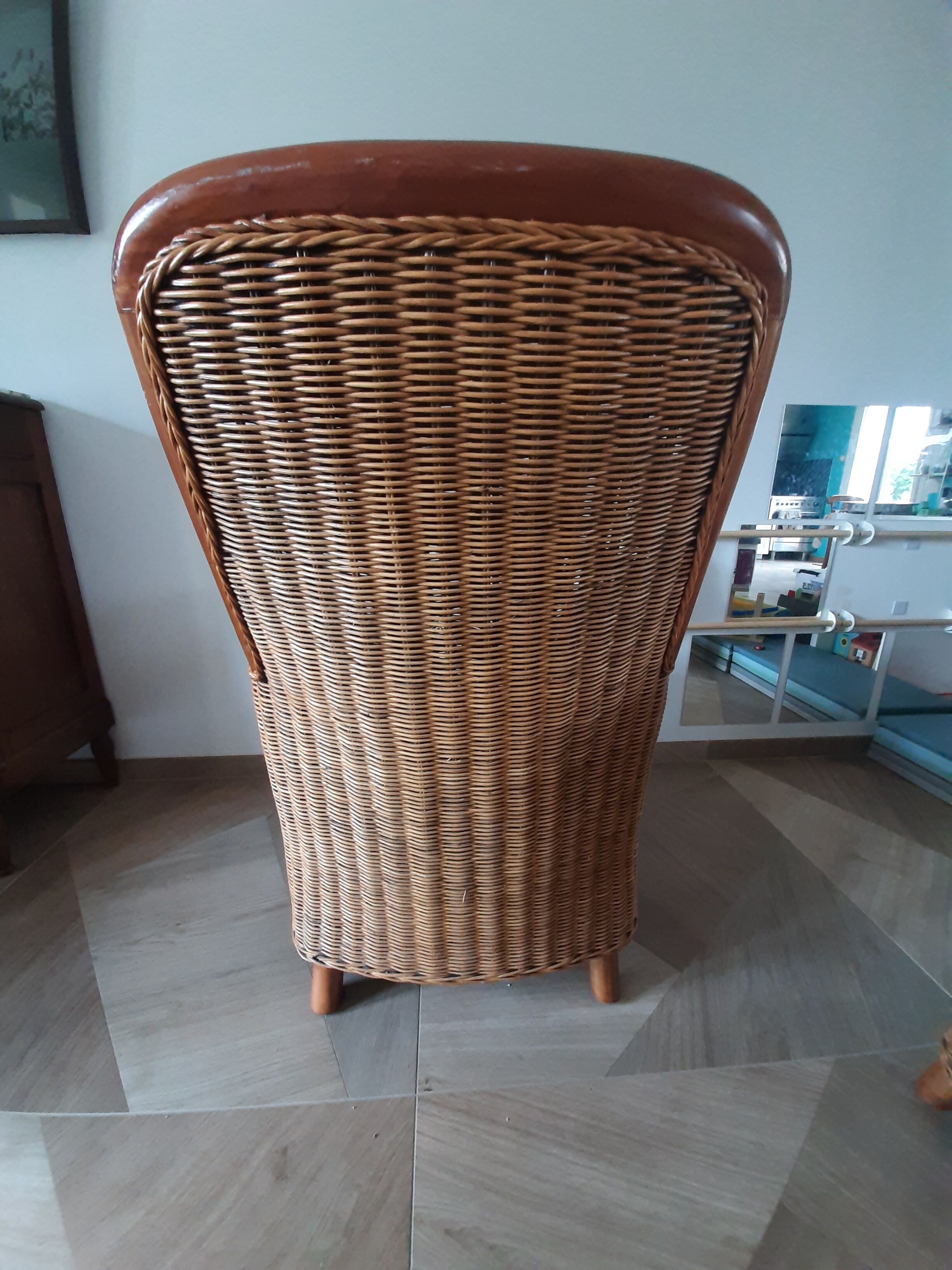 Armchair in woven rattan and exotic wood