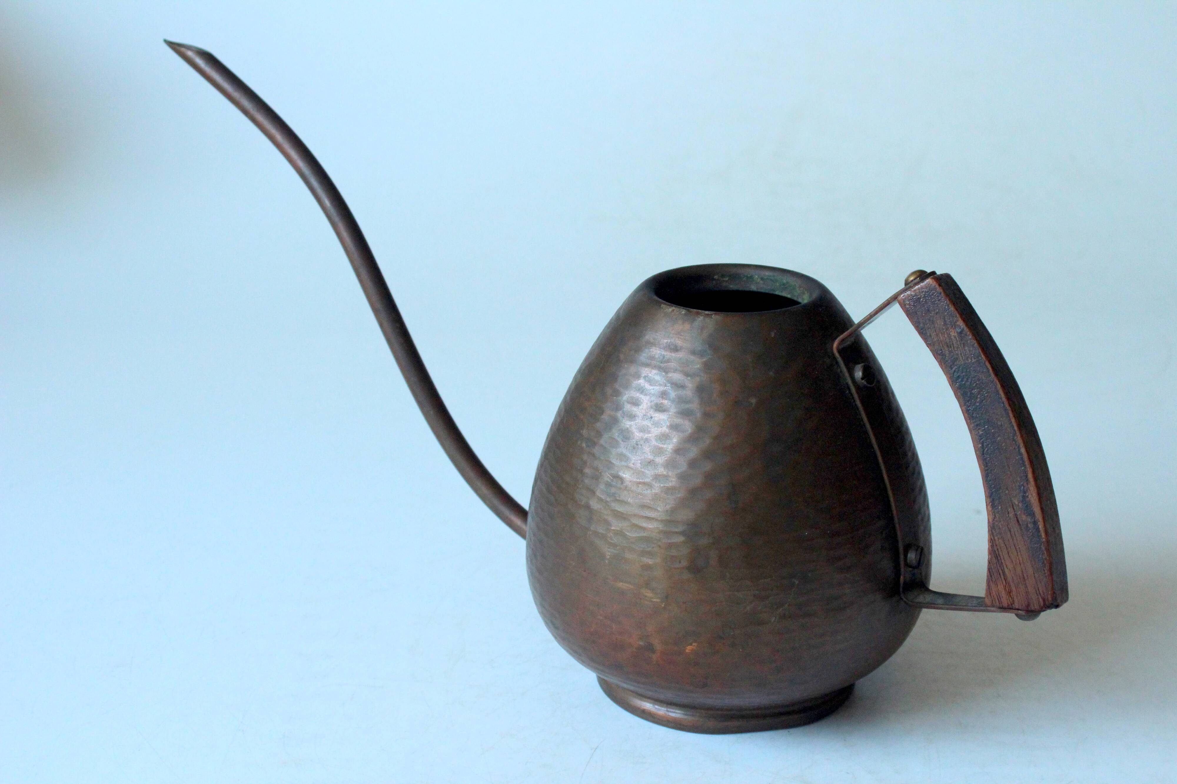 Old copper watering can with wooden handle, complete usuable, vintage from the 1960s