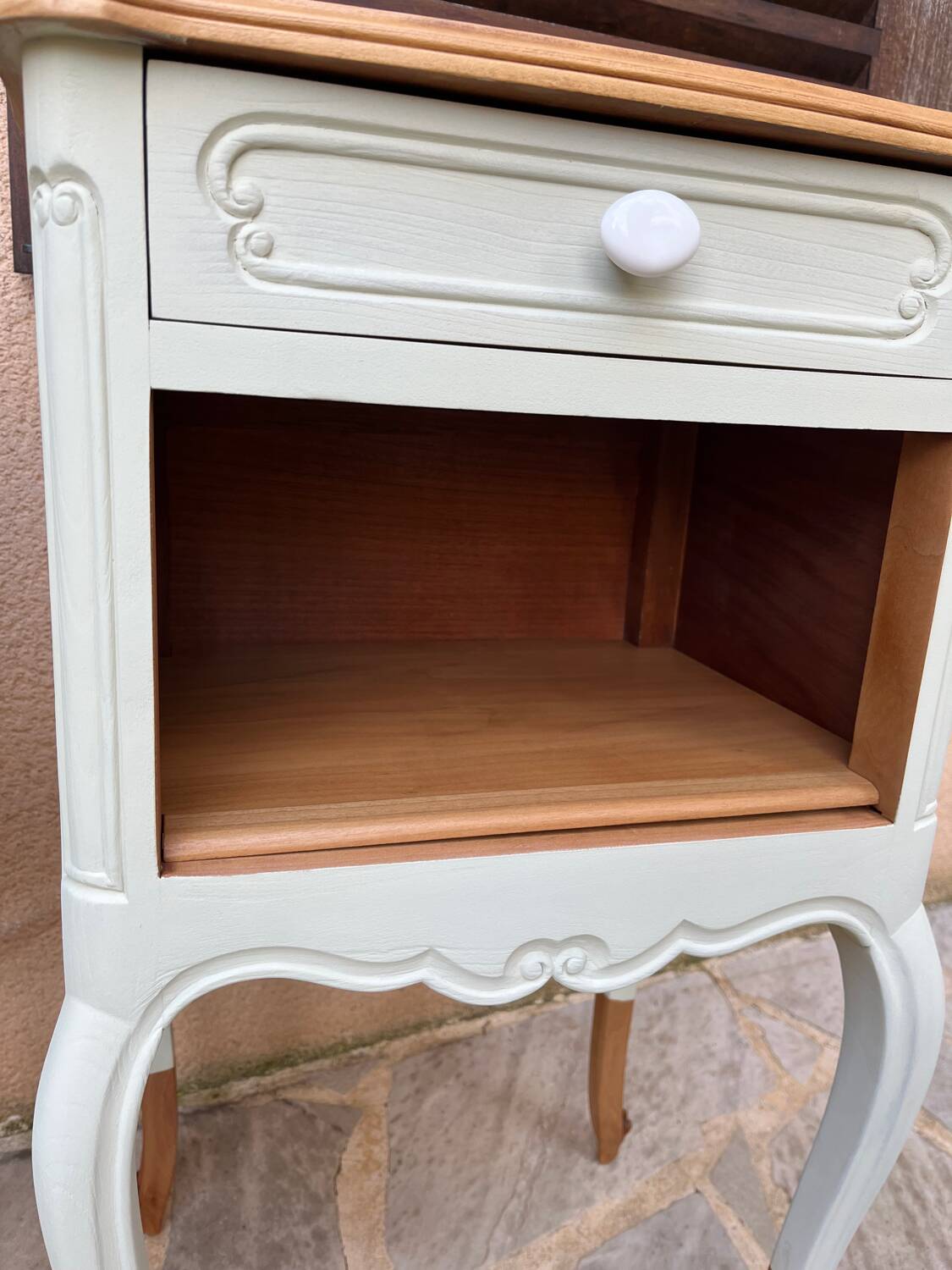 Renovated bedside tables in laurel green and light wood.