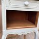 Renovated bedside tables in laurel green and light wood.