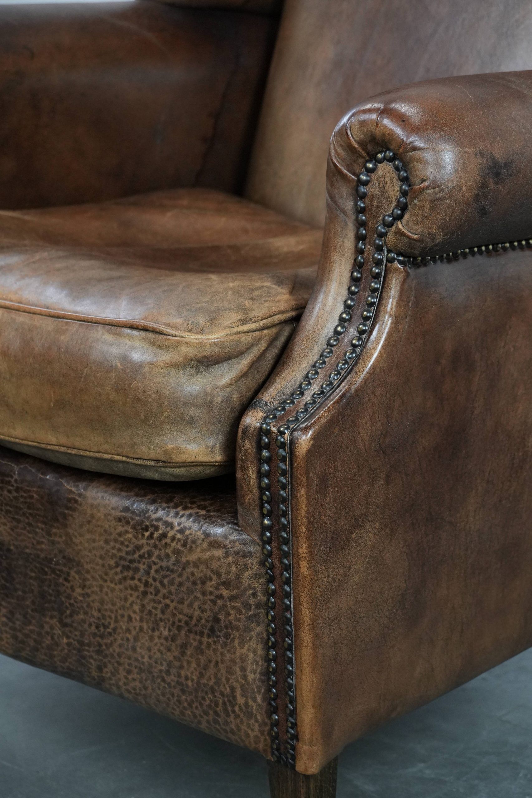 Warm, cosy and comfortable vintage sheepskin ear armchair with character