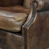 Warm, cosy and comfortable vintage sheepskin ear armchair with character