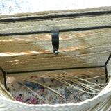 Wall lamp in natural fibres, woven straw with fringes.