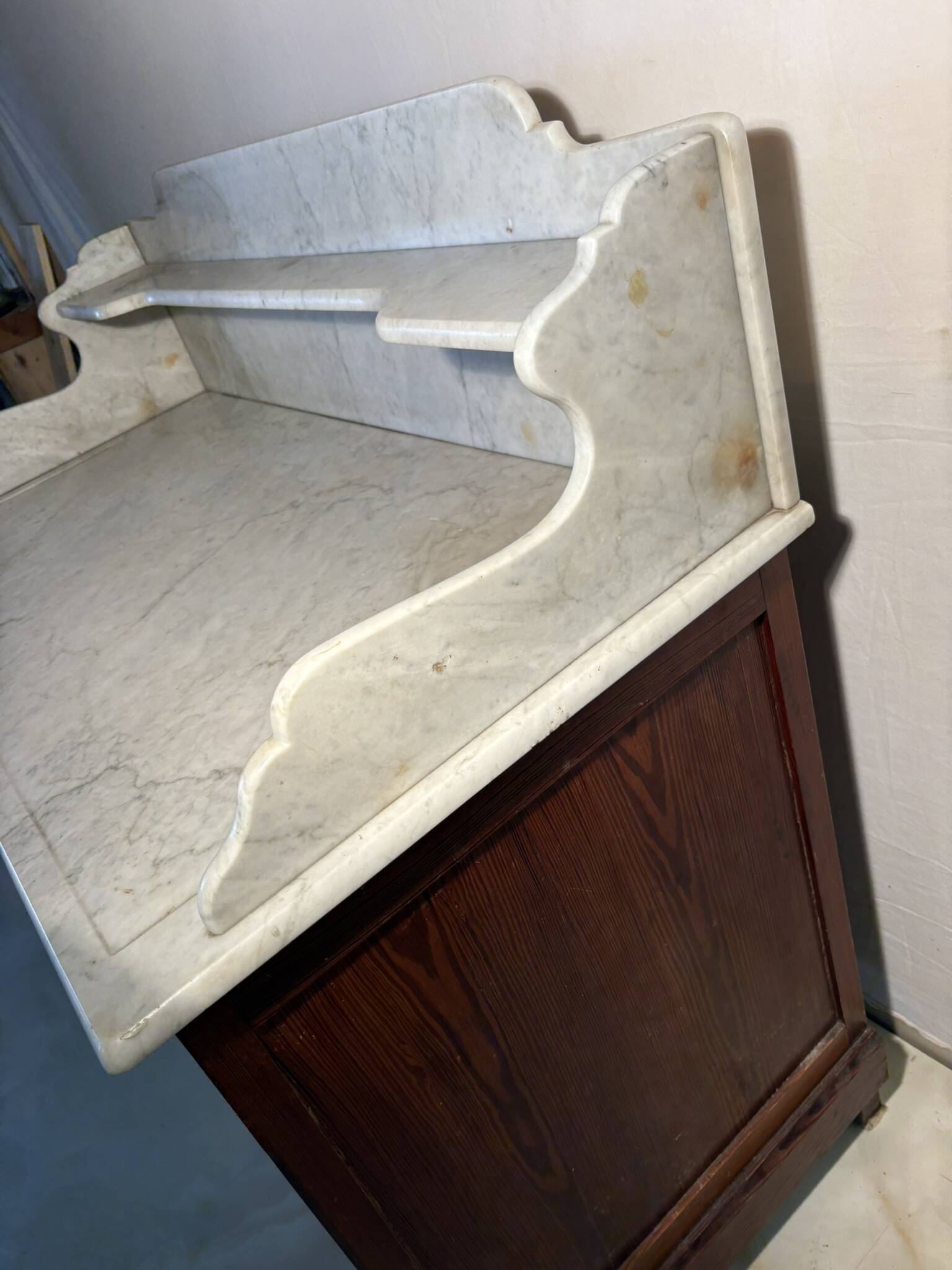 Antique wood and marble kitchen sideboard with carved backsplash