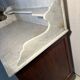 Antique wood and marble kitchen sideboard with carved backsplash