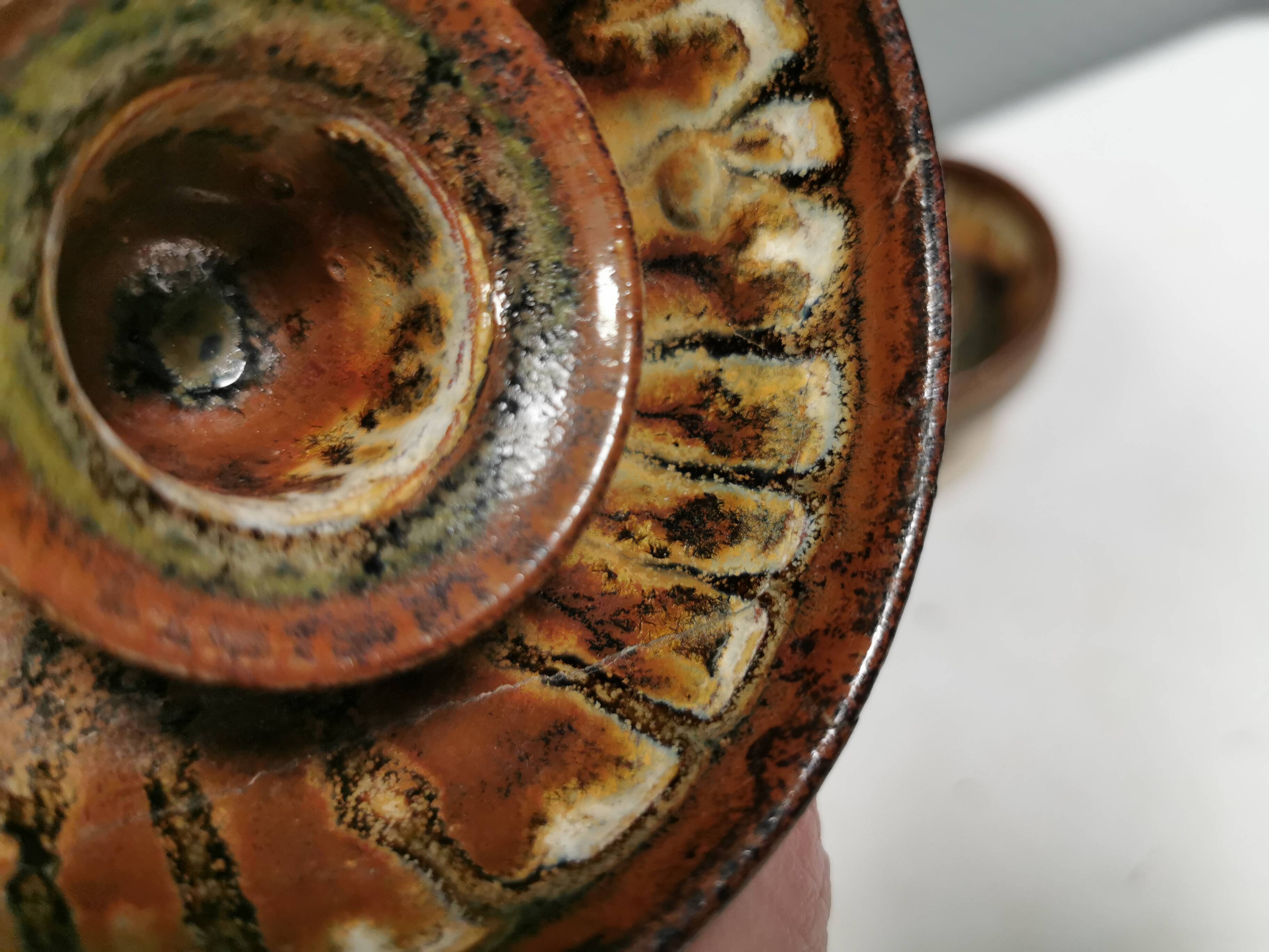 A set of ceramic candle holders in earthy colours.
