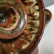 A set of ceramic candle holders in earthy colours.