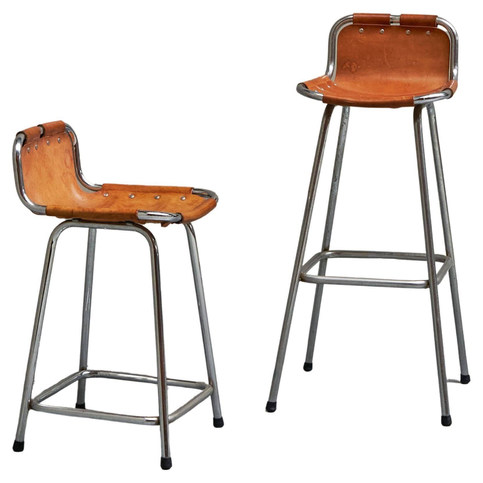 Set of 2 stools "Les Arcs" selected by Charlotte Perriand in leather.