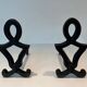 Pair of Cast Iron Chenets with Figurative Anthropomorphic Silhouette, by Raymon