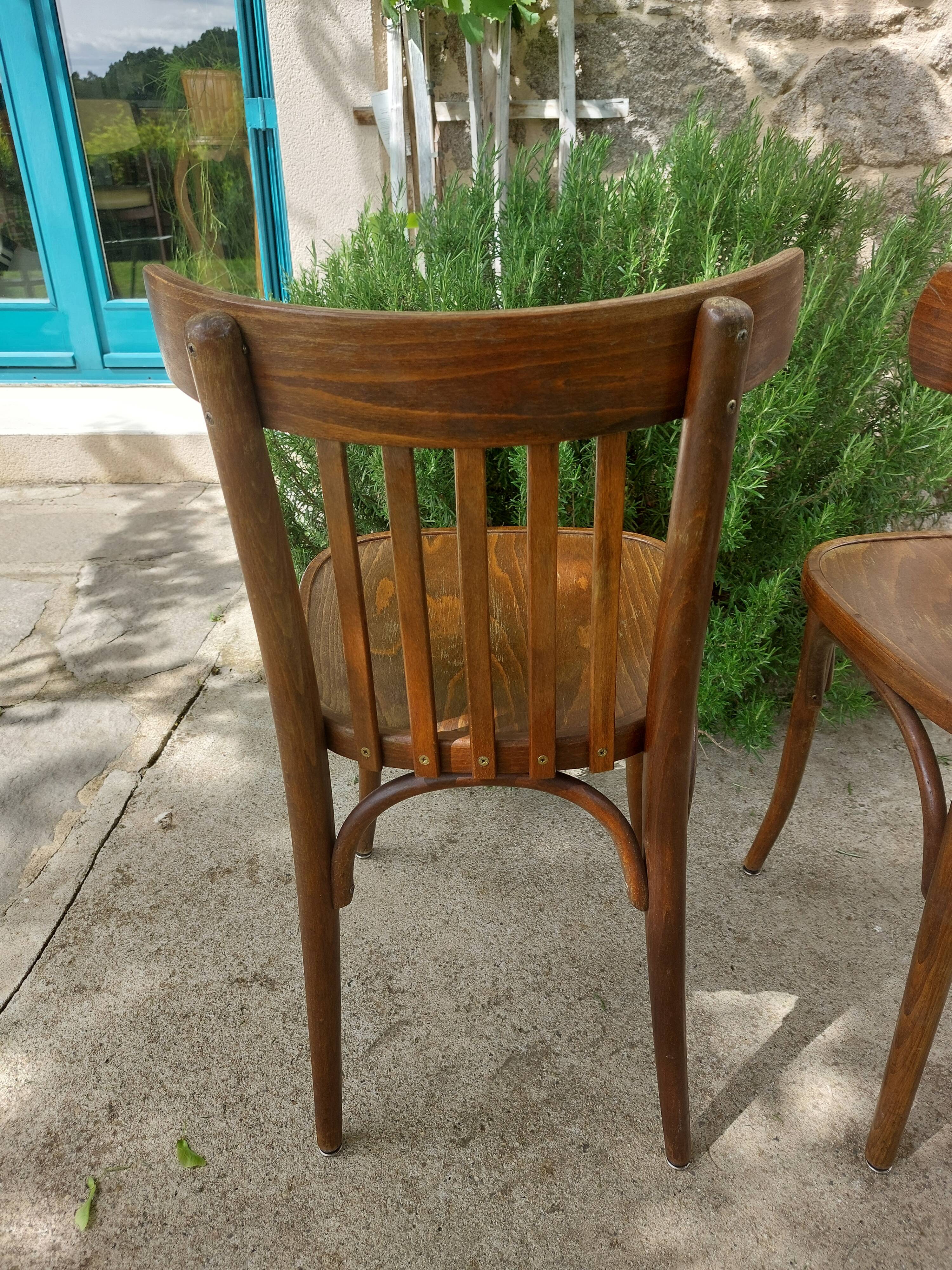 pair of dark bistro chairs, rounded backs, Baumann style