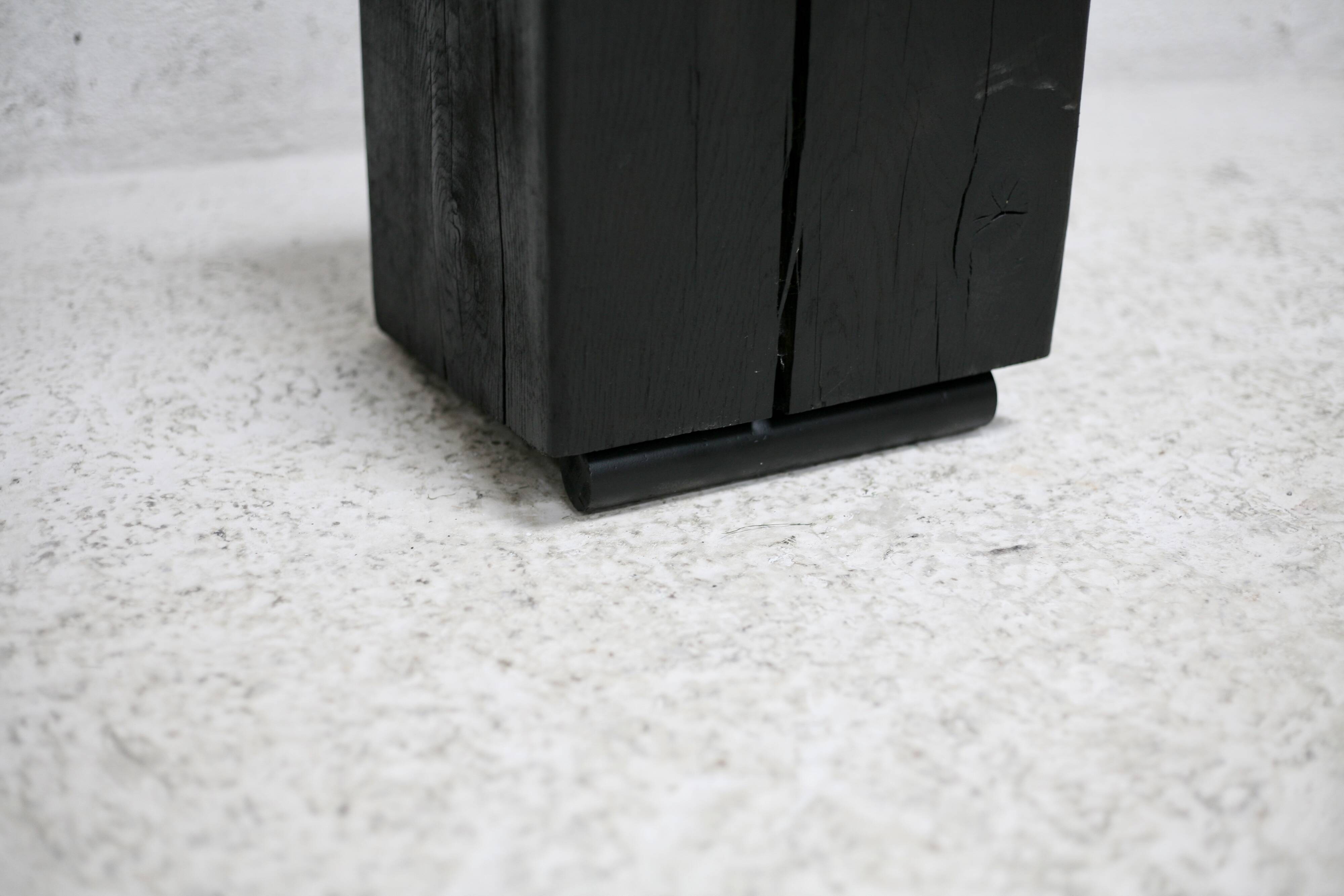 Brutalist chair, black-stained raw wood, steel. Work from the 1970s