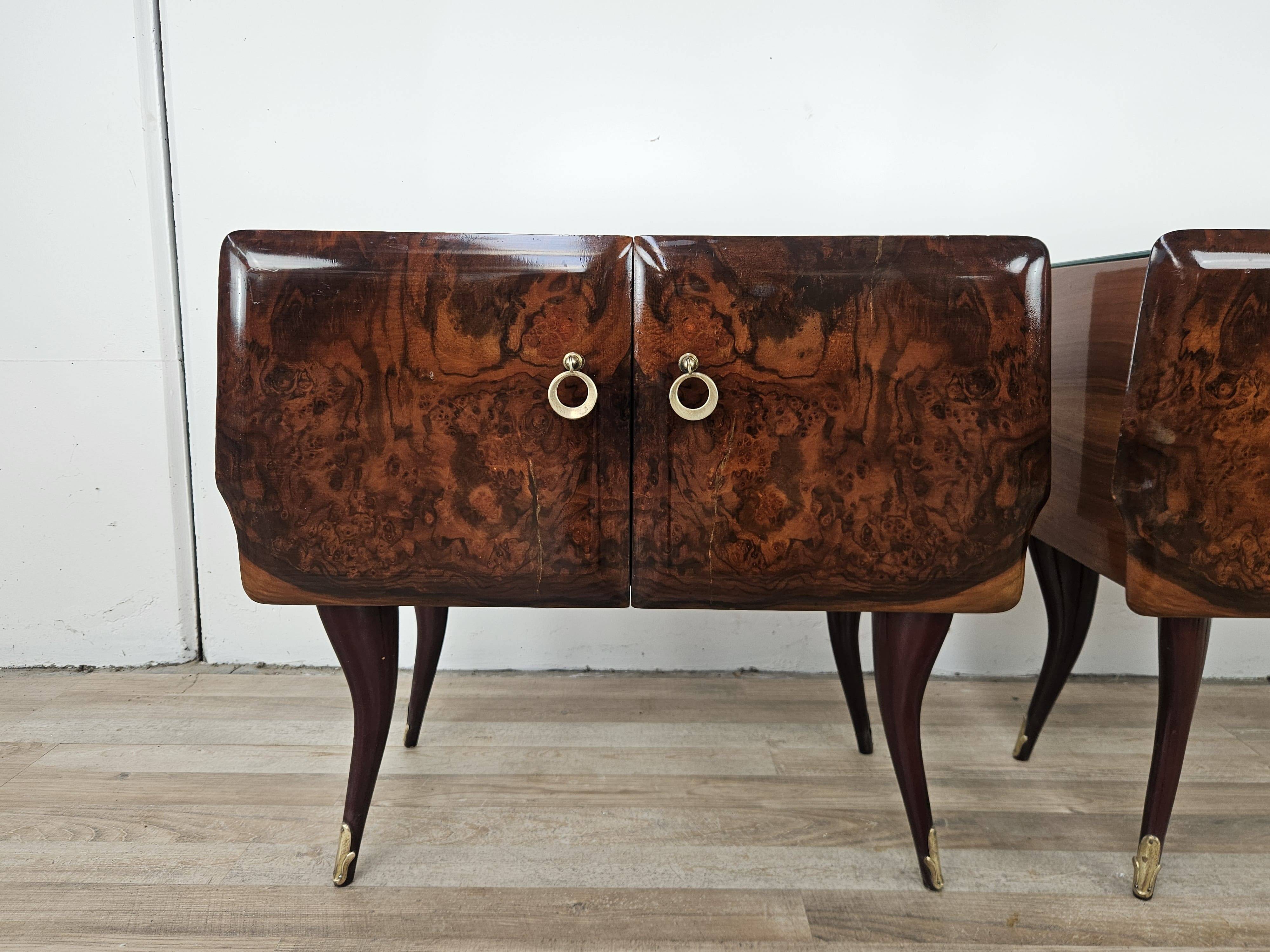 Mid-century mahogany bedside tables with mirrored tops.