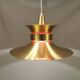 Large hanging lamp, made of brass-coloured aluminium with red and white contrast lacquer inside.