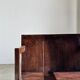 Small low armchair in varnished brown wood