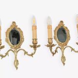 Pair of Louis XV style beveled mirror sconces in bronze by Lucien Gau