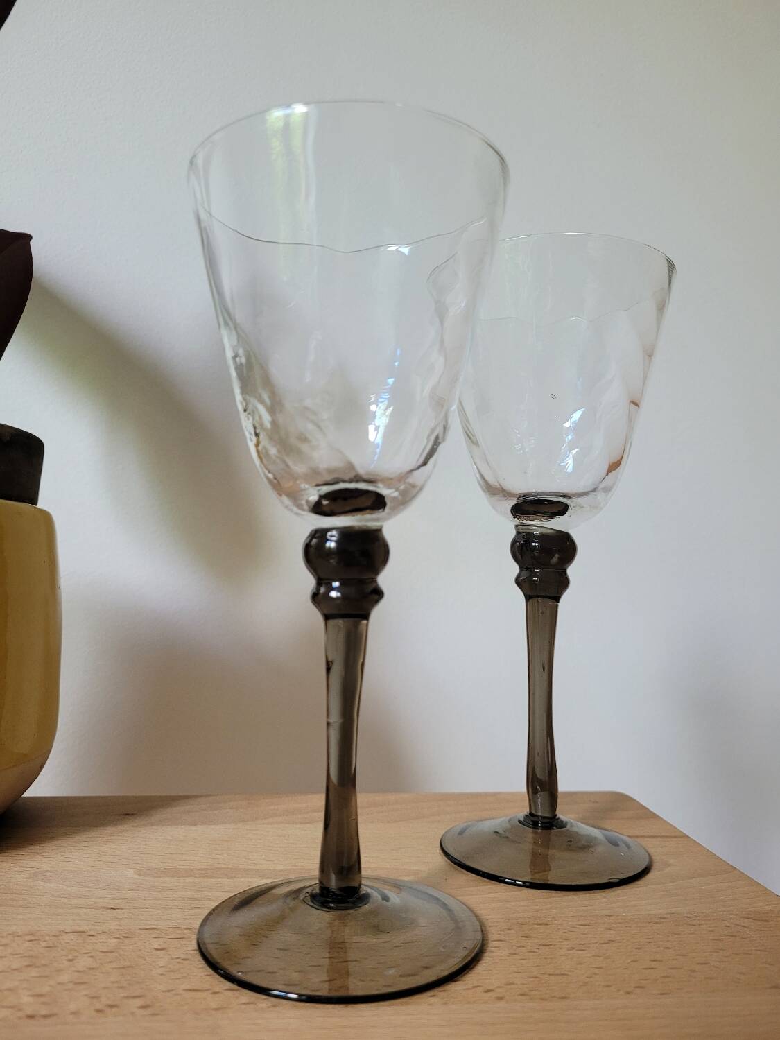 Two smoked black stem wine glasses