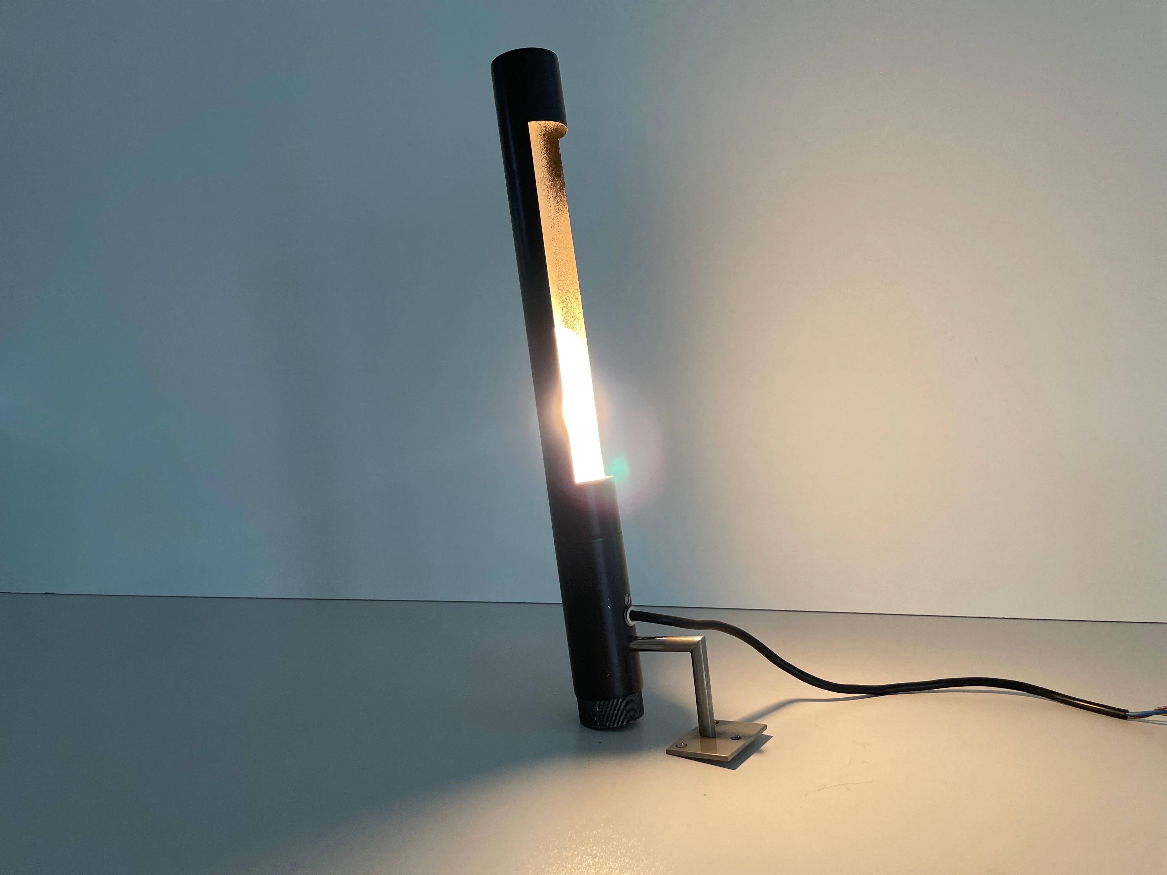 Minimalist black metal wall light with a cylindrical design, 1960s, Germany.