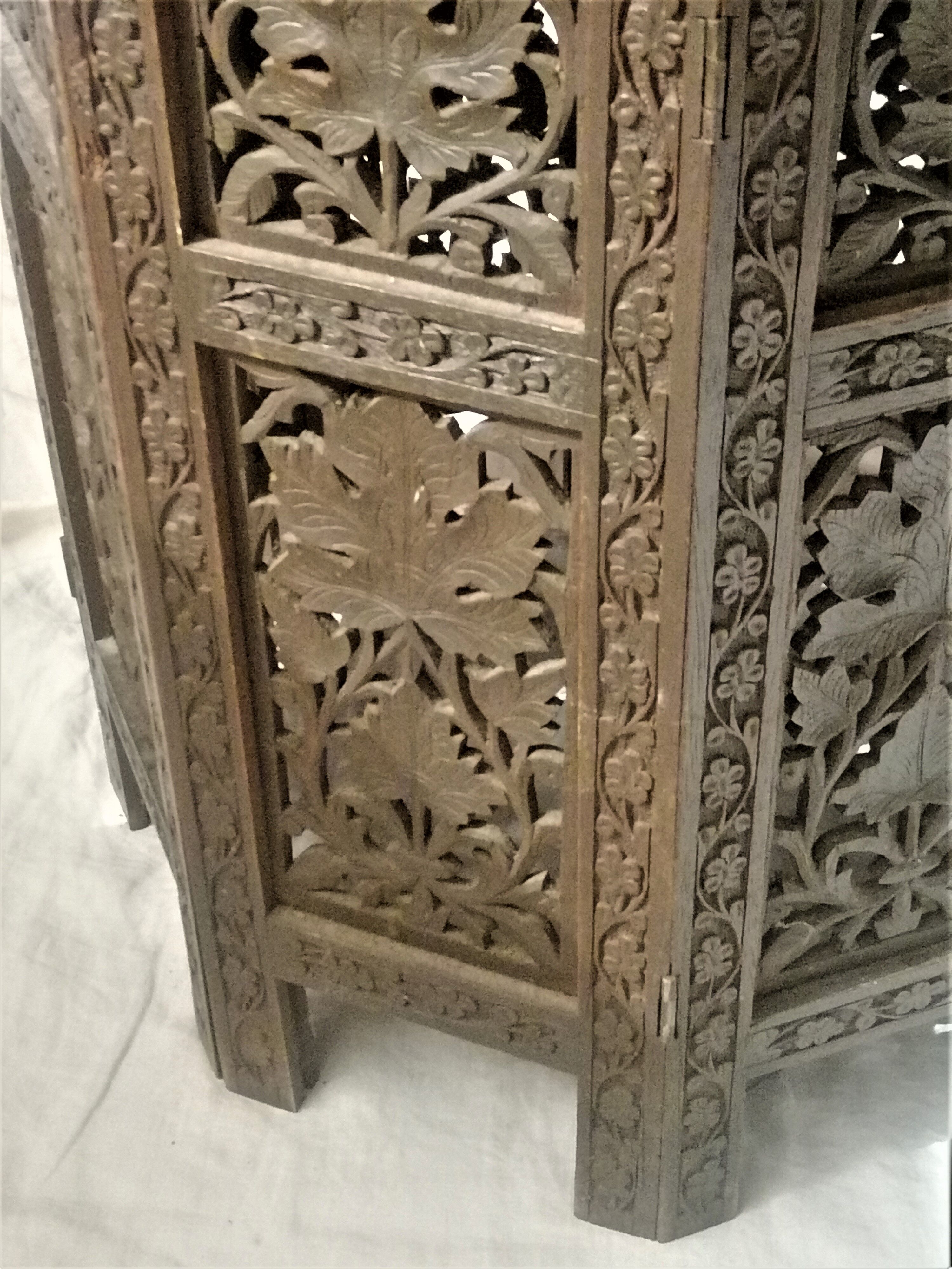 Ancient oriental pedestal table in carved wood