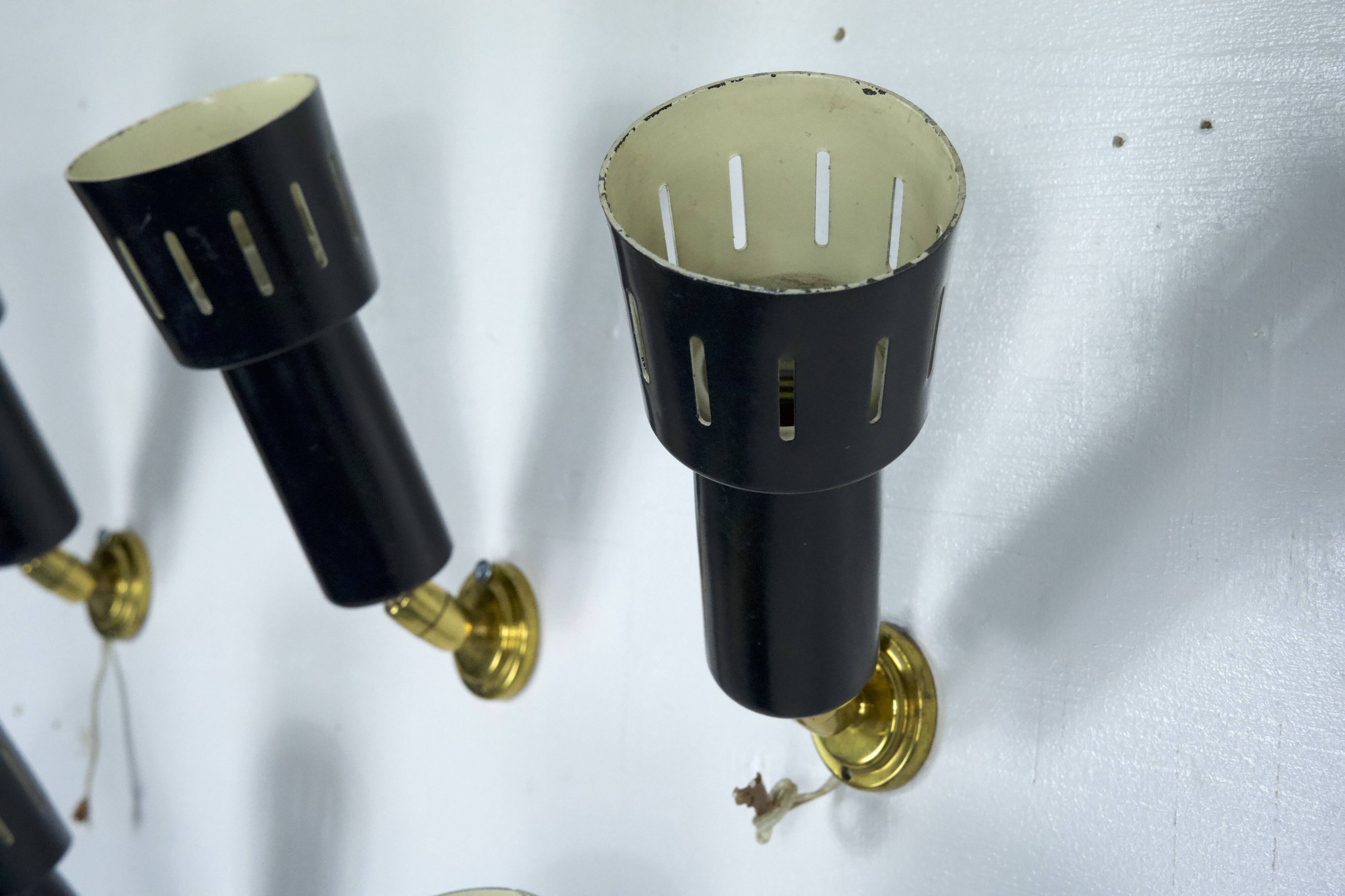 Set of five Stilnovo style spotlights in brass and lacquered metal. Italy