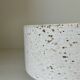 White ceramic vase with a textured effect.