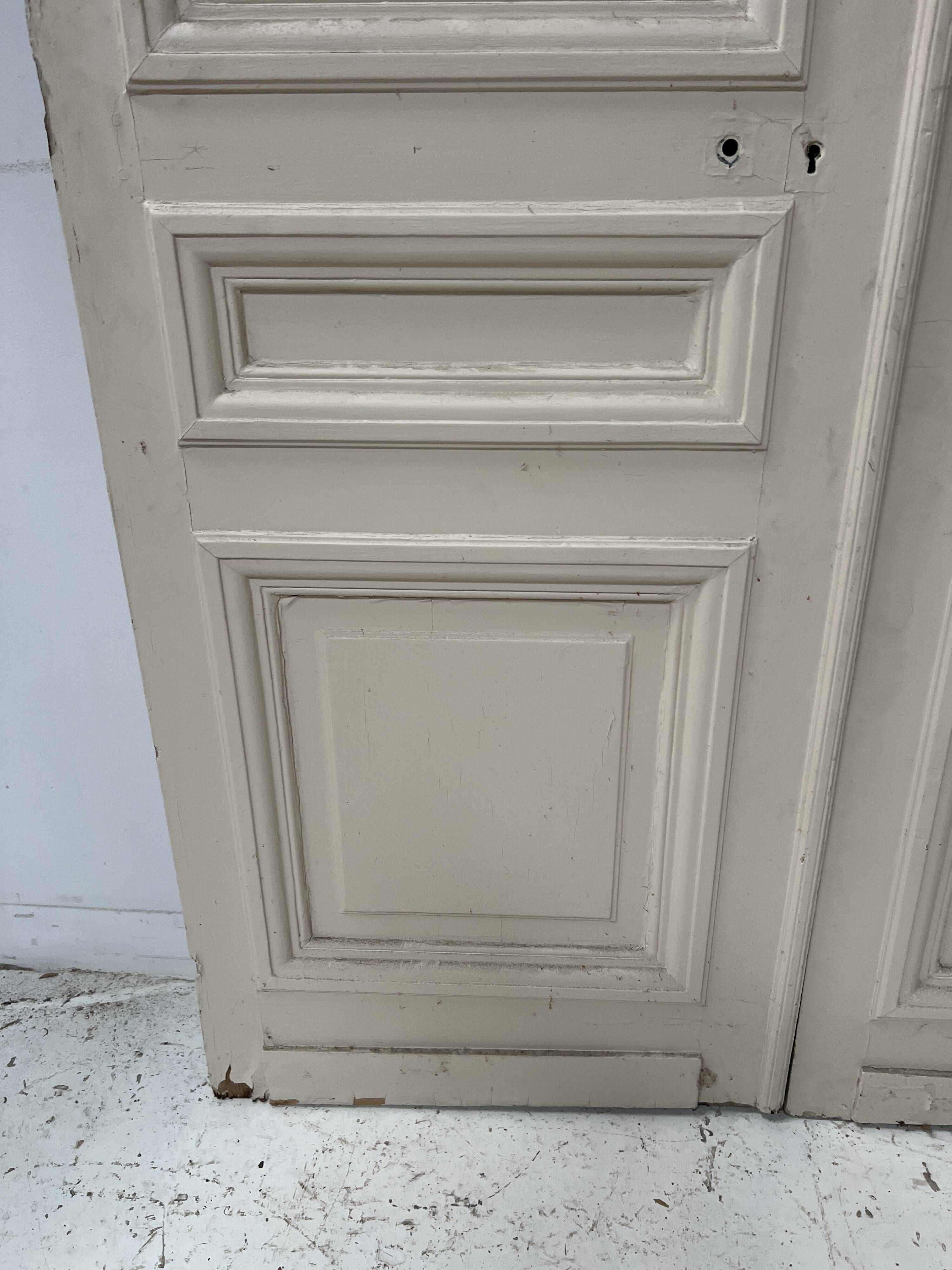 Pair of Haussmann-style double passage doors in patinated oak from the 19th century.