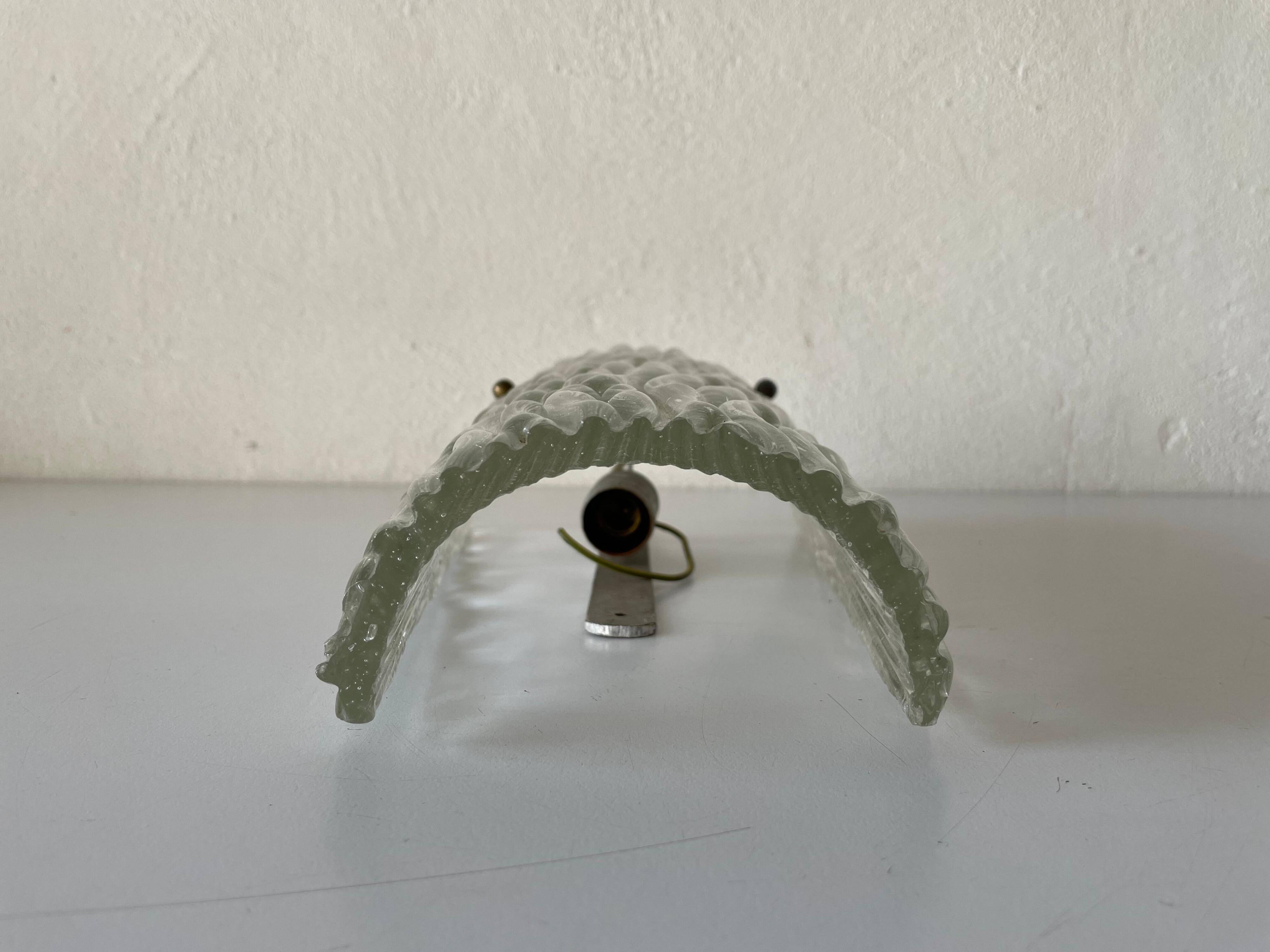 Simple arch-shaped wall light in textured glass, 1950s, Germany.