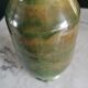 Ancient vase in glazed green terracotta.