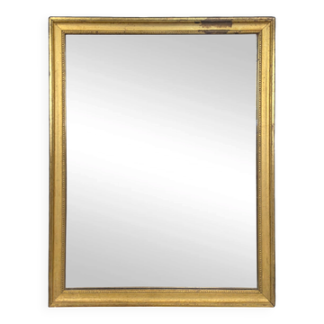 Rectangular mirror with a gold wooden frame.