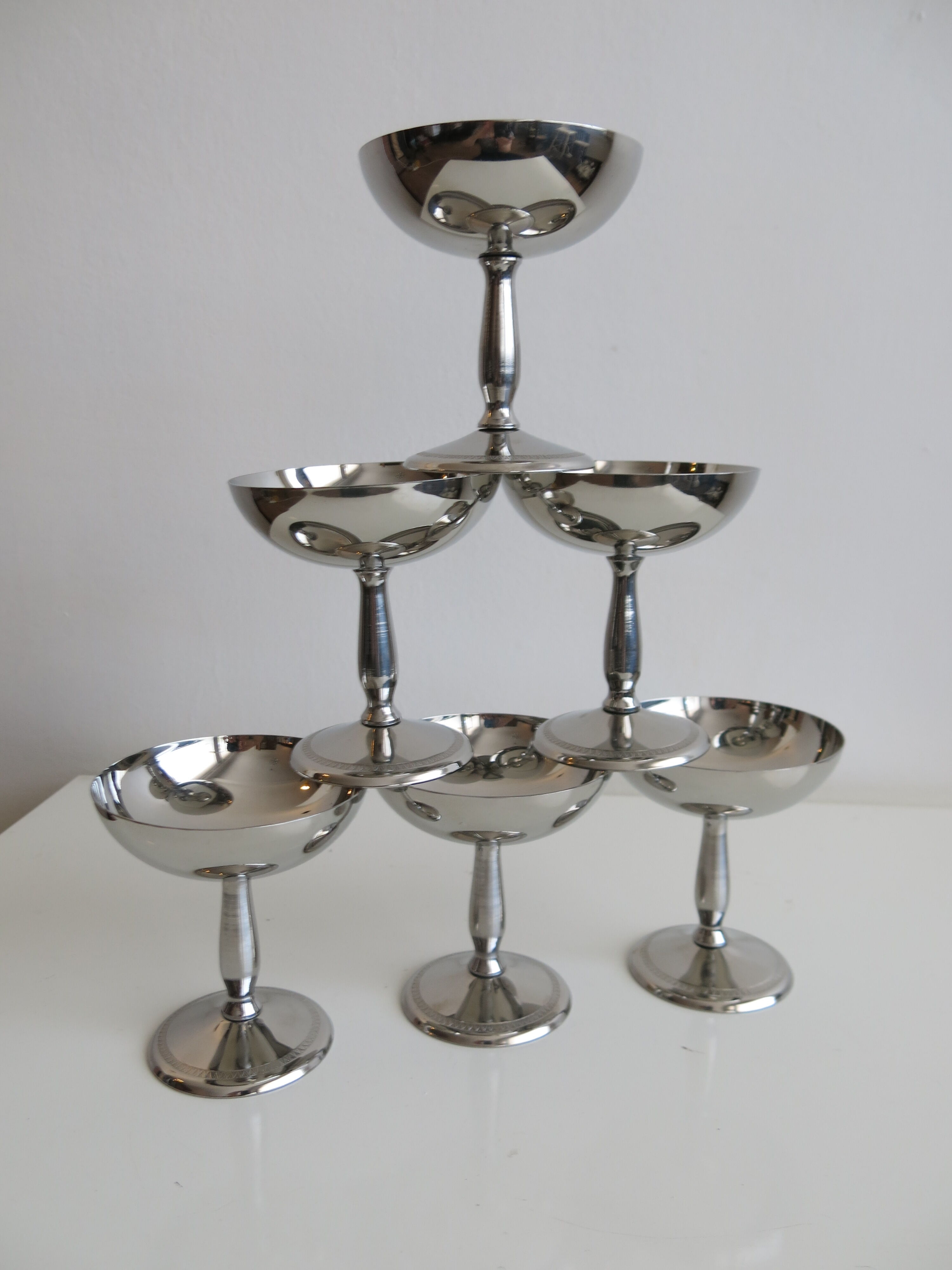 Set of six stainless steel standing cups