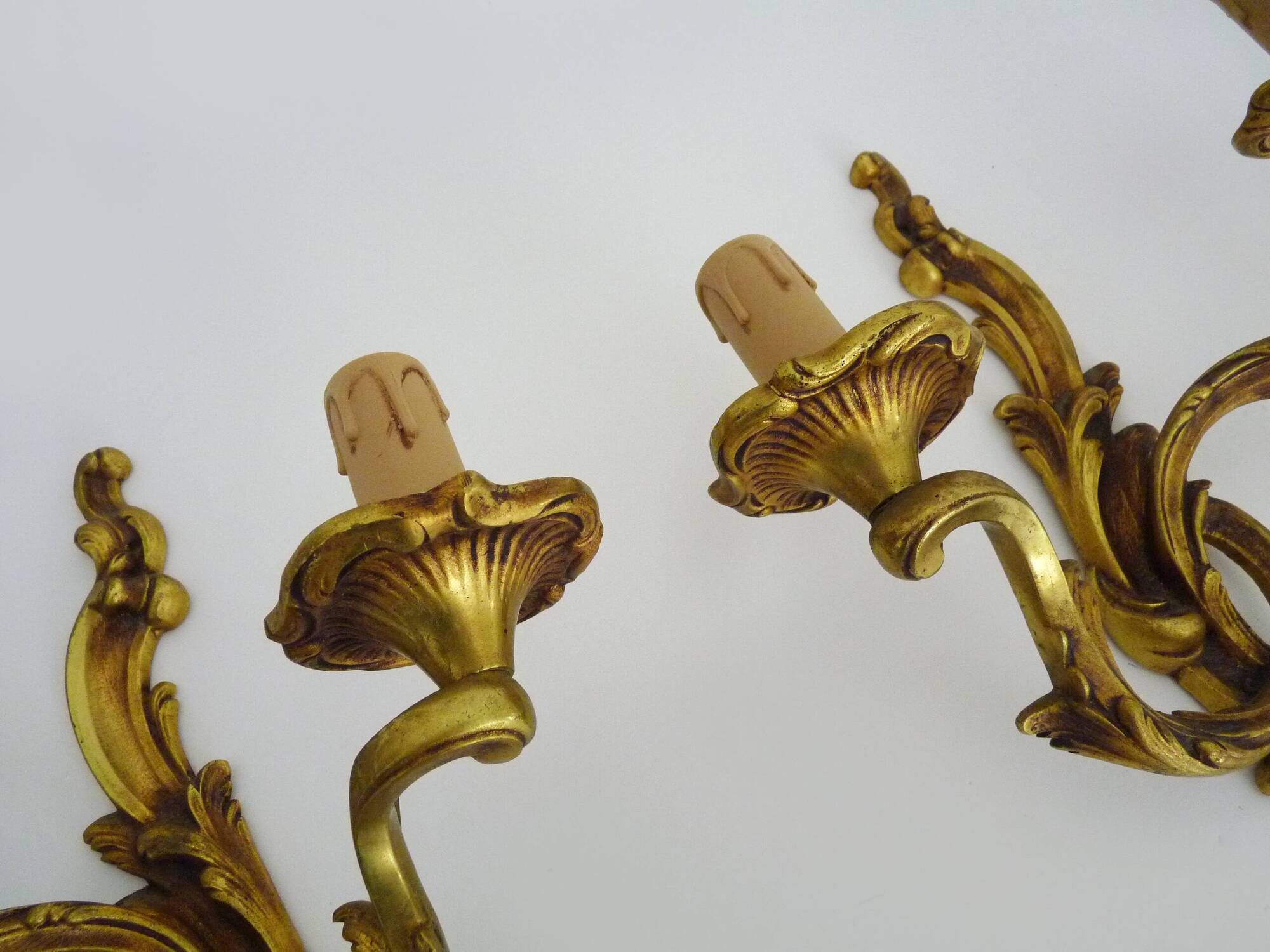 Antique pair of double-light bronze wall sconces with acanthus leaves. 1950s