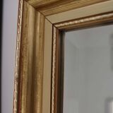 Large beveled mirror in carved wood