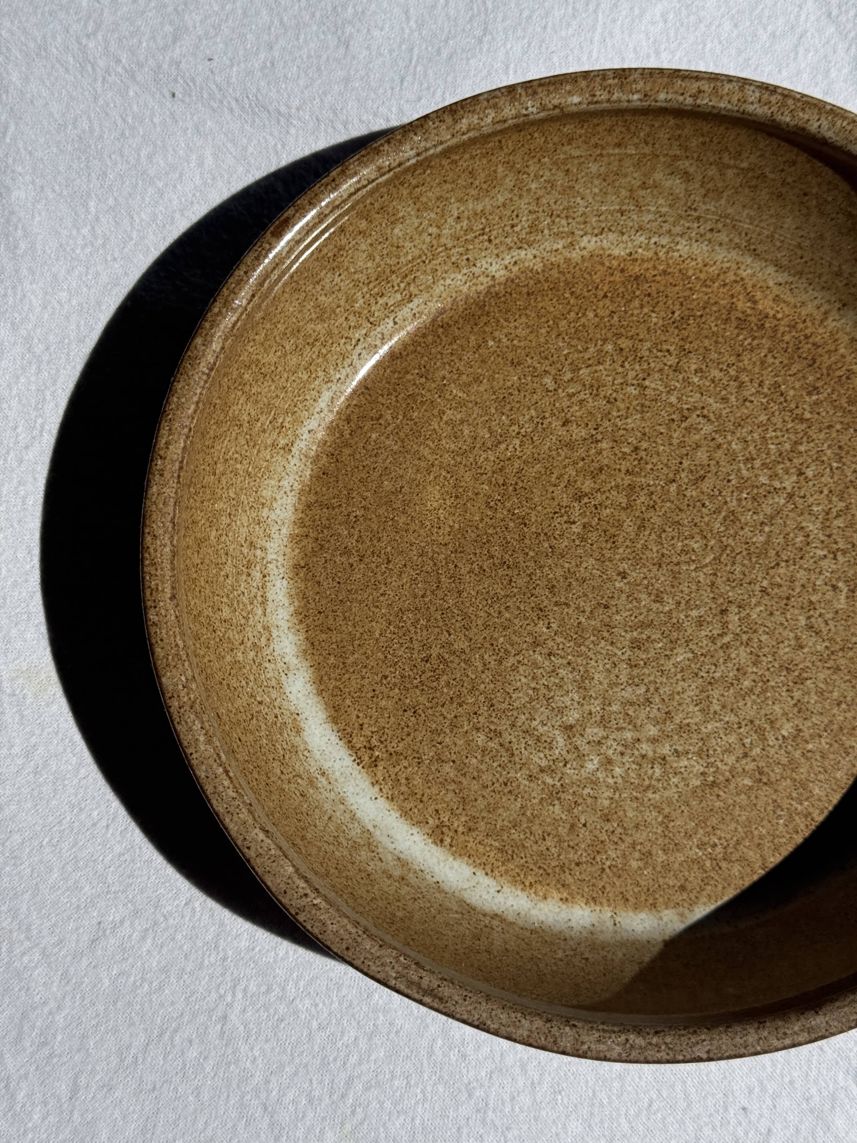 A solid brown flat-bottomed stoneware bowl D18