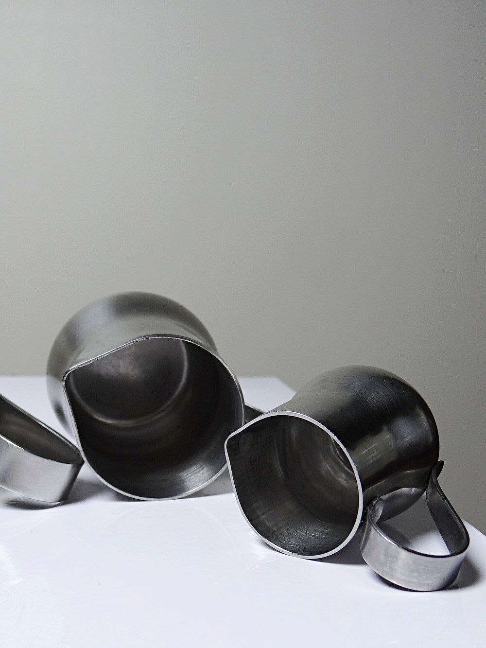 Set of 4 vintage bar measures in brushed stainless steel from the 60s-70s.