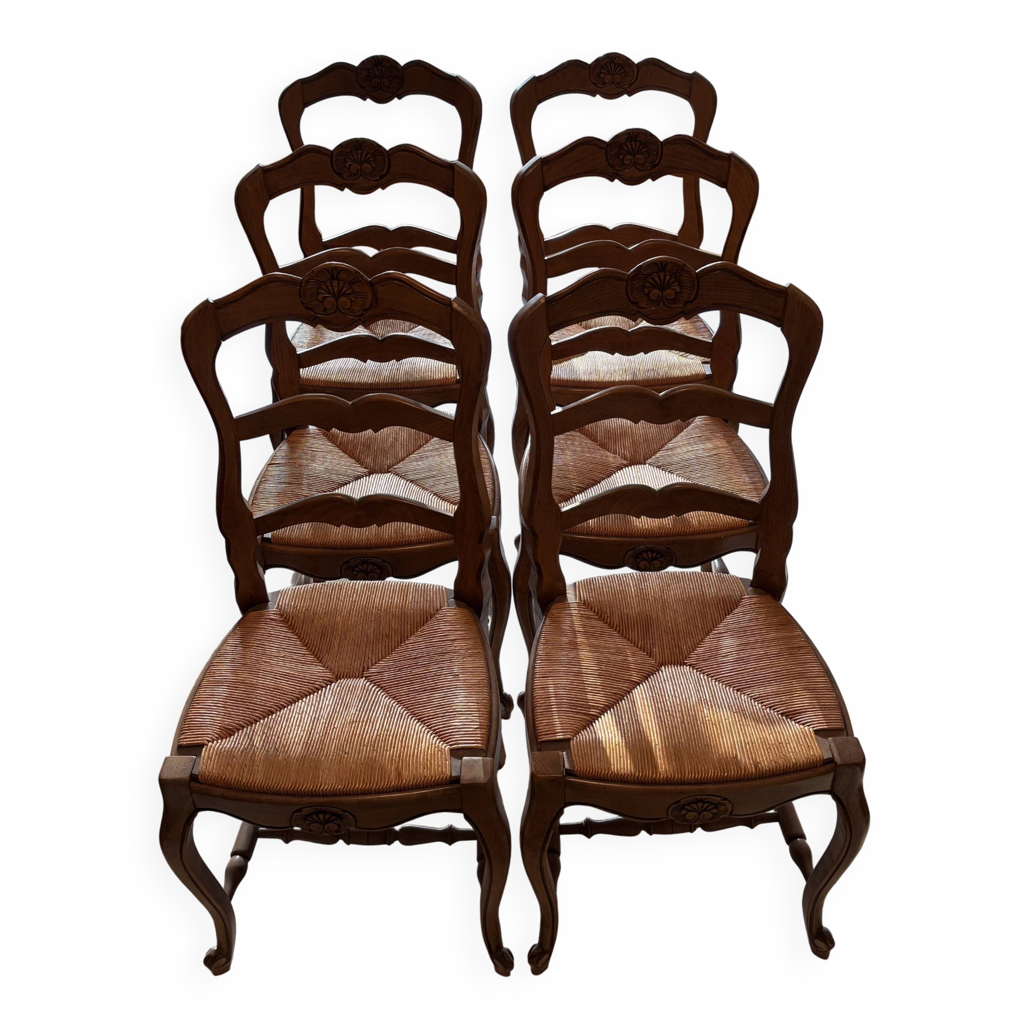 Set of 6 wooden chairs with straw seats.