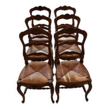 Set of 6 wooden chairs with straw seats.