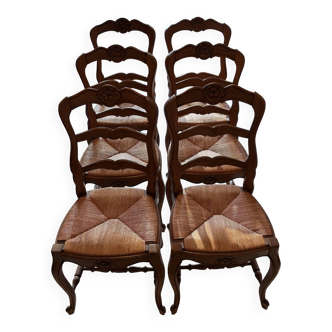 Set of 6 wooden chairs with straw seats.