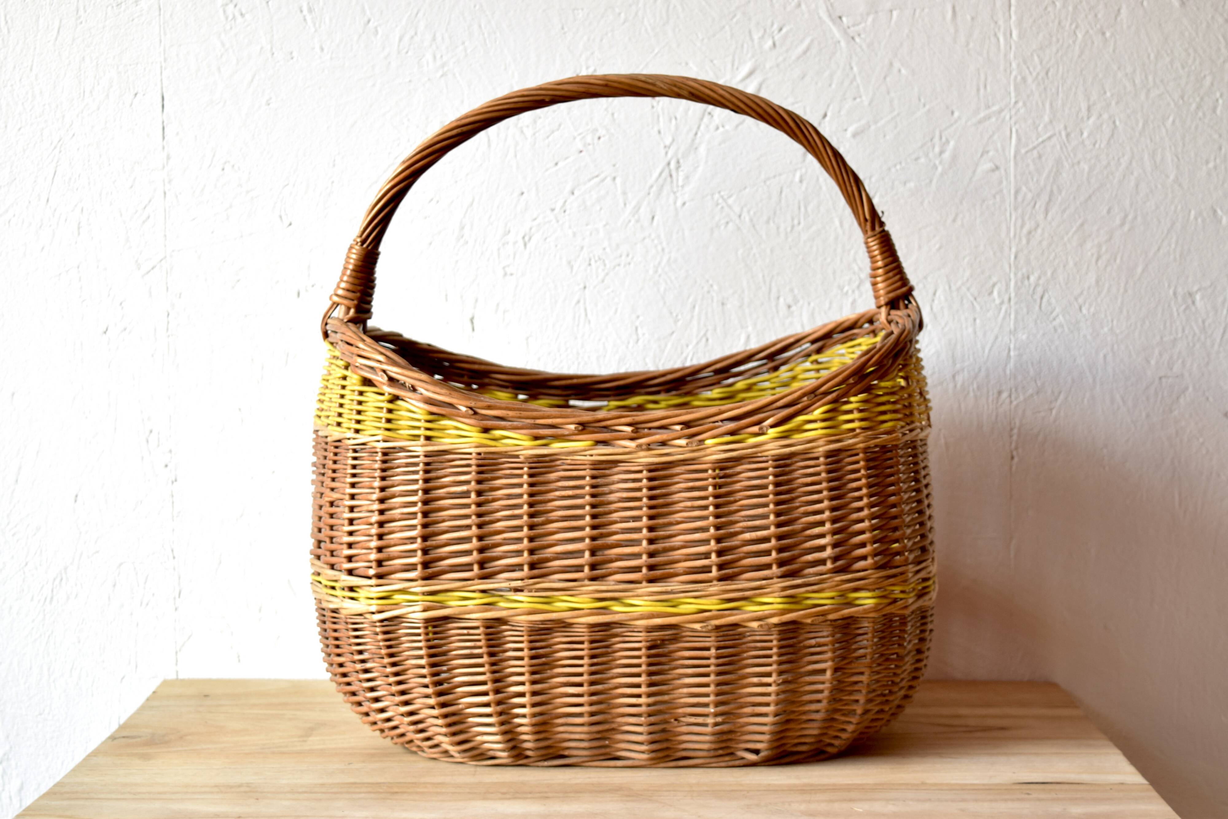 Vintage wicker basket crossed with a yellow scoubidou